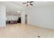 Open-concept living space showcasing neutral tile, ceiling fan, and seamlessly connecting to the kitchen at 196 Morning Glory Dr, Lake Mary, FL 32746