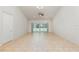 Spacious living room featuring sliding glass doors to screened-in pool, tile flooring, and ample natural light at 196 Morning Glory Dr, Lake Mary, FL 32746