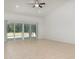 Bright and spacious living room featuring a ceiling fan and sliding glass doors with a view of the pool and outdoor space at 196 Morning Glory Dr, Lake Mary, FL 32746