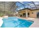 Screened-in pool and patio area with ceiling fan, perfect for outdoor relaxation and entertaining in the backyard at 196 Morning Glory Dr, Lake Mary, FL 32746