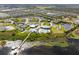 Stunning aerial view showcases the community amenities, including pools, tennis courts, and lush landscaping near the lake at 2301 Datura Loop, St Cloud, FL 34772