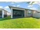 Exterior view of home showing screened-in patio and backyard at 2301 Datura Loop, St Cloud, FL 34772