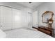 Bright bedroom with white closet doors and a traditional wood dresser at 2301 Datura Loop, St Cloud, FL 34772