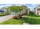 Landscaped front lawn with a charming home, brick-paved driveway, and flowering tree at 2301 Datura Loop, St Cloud, FL 34772