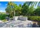 Outdoor stone grill setup surrounded by lush greenery with a stone countertop at 2301 Datura Loop, St Cloud, FL 34772