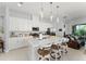 Elegant kitchen featuring a large island with quartz countertops and stainless steel appliances at 2301 Datura Loop, St Cloud, FL 34772