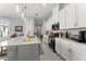 Well-appointed kitchen with white cabinetry, stainless steel appliances, and a spacious island for meal prep at 2301 Datura Loop, St Cloud, FL 34772
