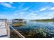 Scenic view of the lake with a gazebo, a dock, and flourishing lily pads in the water at 2301 Datura Loop, St Cloud, FL 34772