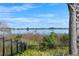 Picturesque lake view with lush vegetation and clear blue sky from community at 2301 Datura Loop, St Cloud, FL 34772