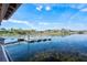 Picturesque view of the lake and community dock with pristine sky reflecting on the clear water at 2301 Datura Loop, St Cloud, FL 34772