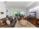 Cozy living room with comfortable seating, large windows with shutter-style blinds, and view of outdoor living space at 2301 Datura Loop, St Cloud, FL 34772
