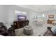 Bright living room features tiled floors, modern furnishings, dining area and large windows with shutter-style blinds at 2301 Datura Loop, St Cloud, FL 34772