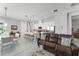 Open-concept living area showcasing dining area, island kitchen with bar stools, and comfortable seating at 2301 Datura Loop, St Cloud, FL 34772