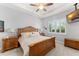Serene bedroom with ceiling fan, large window with plantation shutters, nightstands, and comfortable bed at 2301 Datura Loop, St Cloud, FL 34772