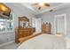 Spacious bedroom with modern decor, ceiling fan, TV, and large window with plantation shutters at 2301 Datura Loop, St Cloud, FL 34772