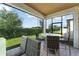 Screened-in patio area with outdoor dining set and green grass at 2301 Datura Loop, St Cloud, FL 34772
