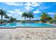 Luxurious pool surrounded by palm trees, lounge chairs, and lush landscaping, perfect for relaxation at 2301 Datura Loop, St Cloud, FL 34772