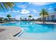 Gorgeous community pool with ample seating, clear blue water, and palm trees at 2301 Datura Loop, St Cloud, FL 34772
