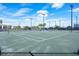 Outdoor tennis courts with professional lighting and well-maintained playing surface under a bright blue sky at 2301 Datura Loop, St Cloud, FL 34772