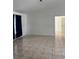 Open living room with neutral paint, tile flooring, and a view into the next room at 233 Red Maple Dr, Kissimmee, FL 34743
