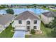 An elevated view of the home, showcasing its well-maintained yard and lake view at 2384 Andrews Valley Dr, Kissimmee, FL 34758