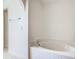 Bathroom featuring a soaking tub with tile surround and chrome fixtures in a bright space at 2384 Andrews Valley Dr, Kissimmee, FL 34758