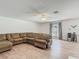 Expansive living room features hardwood floors and a plush, comfortable sectional sofa for ultimate relaxation at 2384 Andrews Valley Dr, Kissimmee, FL 34758