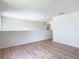 Open loft area with hardwood floors offers versatile space for various activities and customization at 2384 Andrews Valley Dr, Kissimmee, FL 34758