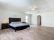 Bright main bedroom featuring wood-look flooring, a ceiling fan, and a large walk-in closet at 2384 Andrews Valley Dr, Kissimmee, FL 34758