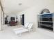 Covered patio featuring lounge chairs, a dining table, and an arched window at 2384 Andrews Valley Dr, Kissimmee, FL 34758