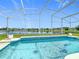 Inviting screened-in pool with a tiled trim, offering a beautiful waterfront view at 2384 Andrews Valley Dr, Kissimmee, FL 34758