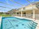 A refreshing in-ground pool enclosed in a screened area with clear blue water at 2384 Andrews Valley Dr, Kissimmee, FL 34758