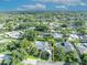 Aerial view of a property featuring a private pool and meticulously landscaped grounds surrounded by lush greenery at 2450 Mcintosh Way, Maitland, FL 32751