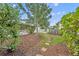 Well-maintained backyard with lush greenery, mature trees, and a stone pathway leading through the yard at 2450 Mcintosh Way, Maitland, FL 32751