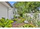 Lush backyard featuring a stone bench and serene landscaping, creating a peaceful outdoor space at 2450 Mcintosh Way, Maitland, FL 32751