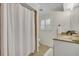Updated bathroom featuring a shower, shuttered window, granite vanity, and neutral color palette at 2450 Mcintosh Way, Maitland, FL 32751