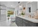 Elegant bathroom featuring double vanities, a soaking tub, and a view of the serene backyard at 2450 Mcintosh Way, Maitland, FL 32751