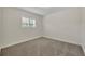 Simple bedroom with neutral carpet and a single window provides a tranquil space at 2450 Mcintosh Way, Maitland, FL 32751