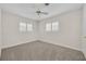 This cozy bedroom features chair rail detail and two windows with shutters at 2450 Mcintosh Way, Maitland, FL 32751