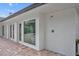 Exterior view featuring an outdoor shower, brick pavers, and a large picture window at 2450 Mcintosh Way, Maitland, FL 32751