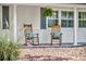 Relaxing front porch with rocking chairs, fern and brick flooring, perfect for enjoying quiet moments at 2450 Mcintosh Way, Maitland, FL 32751
