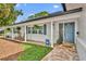 Inviting front porch with brick accents, rocking chairs, and charming curb appeal at 2450 Mcintosh Way, Maitland, FL 32751