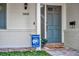 Inviting front porch with brick accents, vibrant house number, blue door and a cheerful 'hello' welcome mat at 2450 Mcintosh Way, Maitland, FL 32751