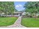 Charming single-story home with lush lawn, brick walkway, and inviting curb appeal at 2450 Mcintosh Way, Maitland, FL 32751
