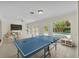 Spacious game room with a ping pong table and views of the beautiful backyard pool area at 2450 Mcintosh Way, Maitland, FL 32751