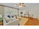 Bright living room featuring hardwood floors, neutral decor, plantation shutters, and ceiling fan at 2450 Mcintosh Way, Maitland, FL 32751
