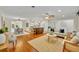 Open-concept living space with hardwood floors, neutral decor, and seamless flow to kitchen at 2450 Mcintosh Way, Maitland, FL 32751
