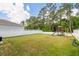 Large backyard with playset, a privacy fence, and lush lawn perfect for outdoor activities at 266 Caryota Ct, New Smyrna Beach, FL 32168