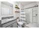 Modern bathroom featuring granite countertops, a walk-in shower, and stylish black and white accents at 266 Caryota Ct, New Smyrna Beach, FL 32168