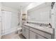 Bright bathroom with double vanity, granite countertop, framed mirror, and shower-tub combo at 266 Caryota Ct, New Smyrna Beach, FL 32168